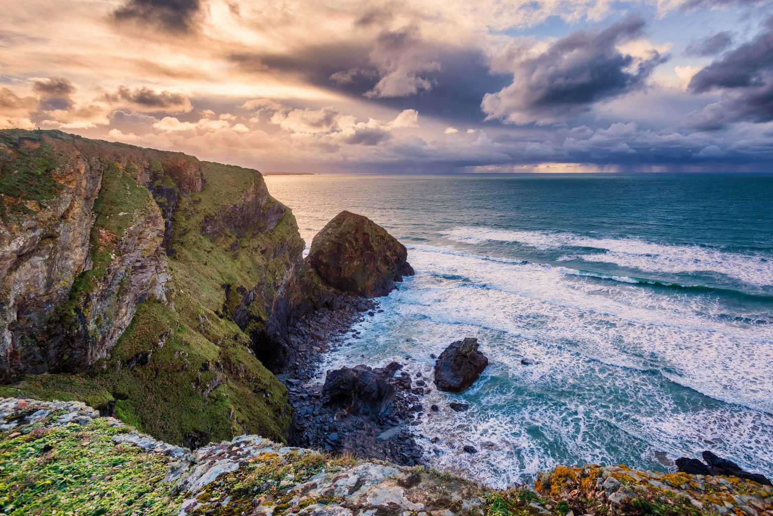 Waves meeting the dramatic cliffs at Bedruthan Steps, Cornwall
